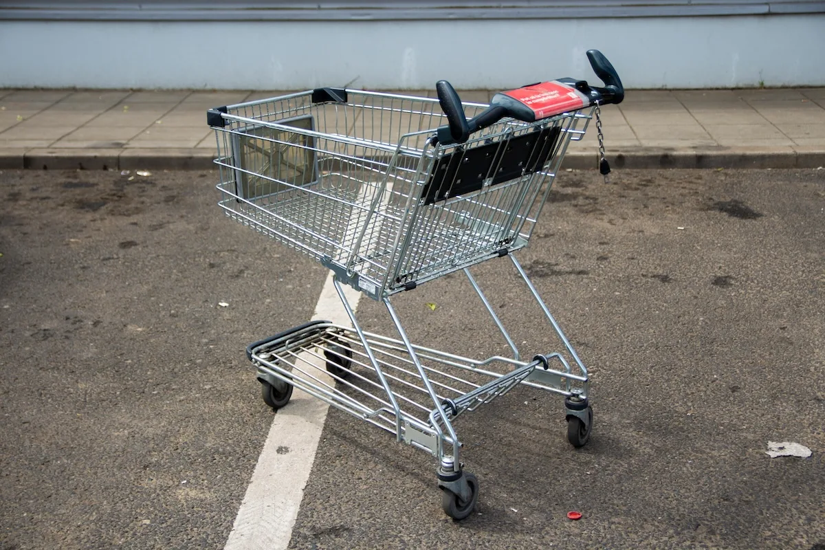 Покинутий візок для покупок на парковці – символ кризи в роздрібній торгівлі та банкрутства дискаунтерних мереж.