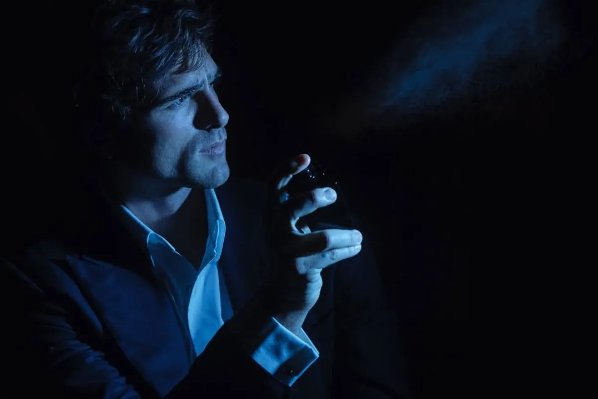 Jacob Elordi Bleu de Chanel. Чоловік в елегантному костюмі розпилює парфуми Bleu de Chanel у темному, атмосферному місці, освітленому холодним блакитним світлом. Знімок підкреслює розкішний характер аромату Chanel та сучасний образ мужності, пов'язаний з Jacob Elordi.
