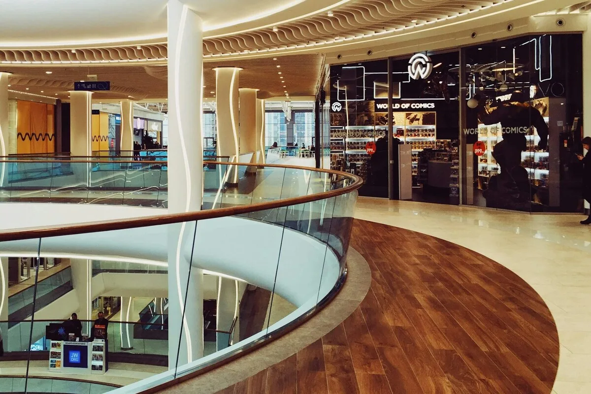 Alfa Centrum Gdańsk. Сучасний торговий центр зі скляними балюстрадами та магазинами на задньому плані – ілюстративне фото. Такі будівлі все частіше закриваються та зносяться через зміни на ринку роздрібної торгівлі. На їхньому місці будуються нові забудови, найчастіше житлові.